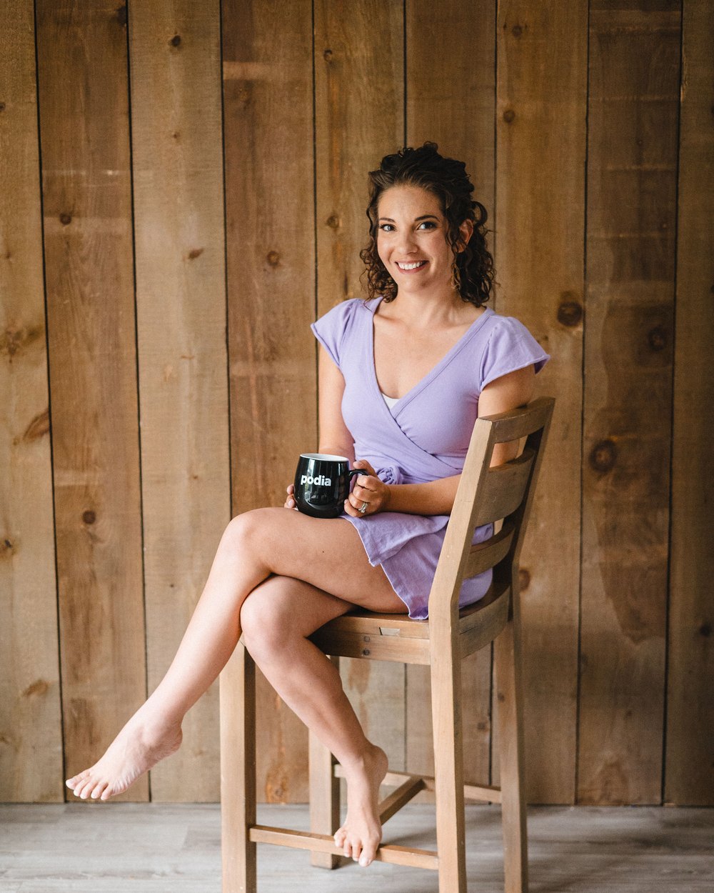 Brittany Hardy, mortgage broker website designer, holding a Podia mug